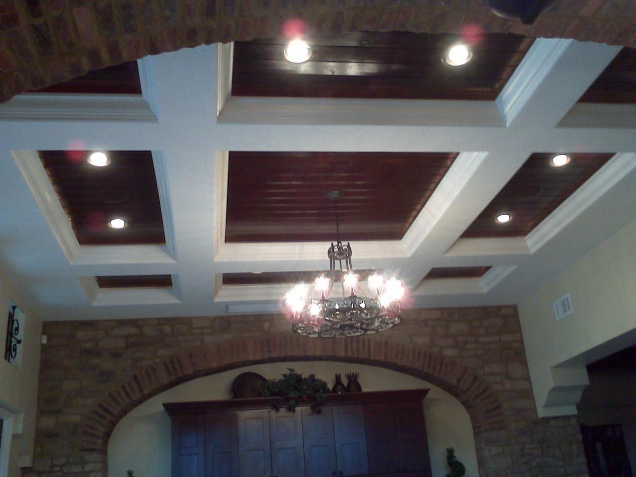 Coffered ceiling with stained wood insets and chandelier